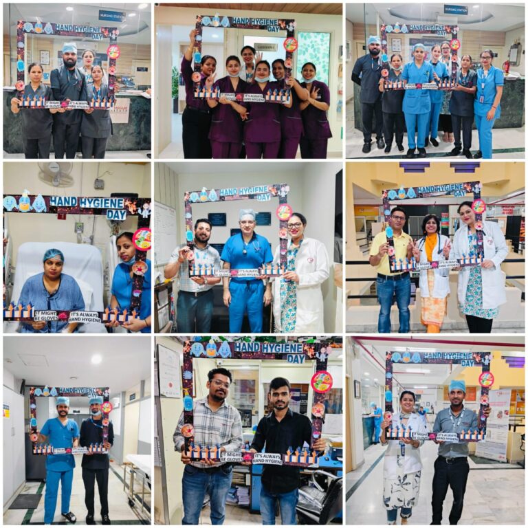 ACE Heart Institute staff holding a colorful banner promoting hand hygiene awareness.